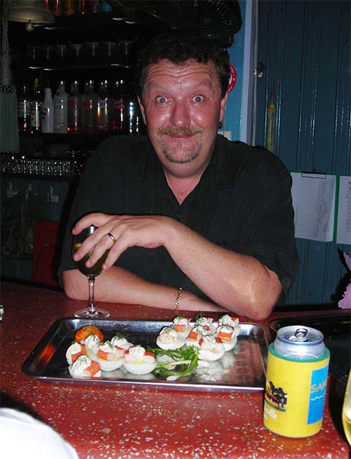 ola working at his bar, the blue frog, in sihanoukville, cambodia